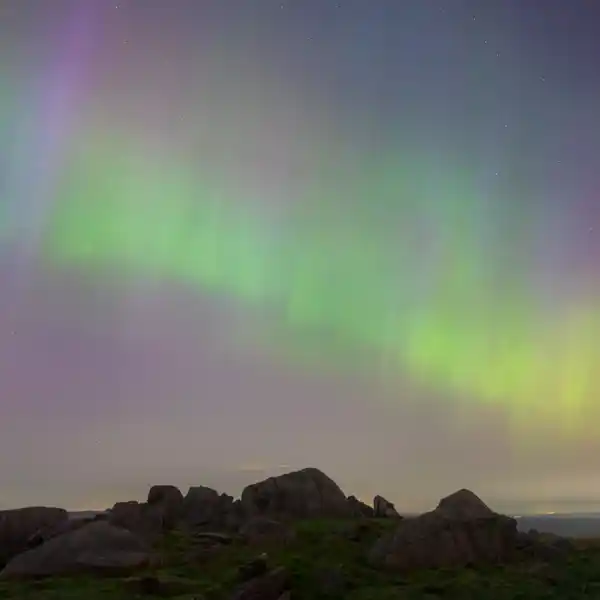 Aurora Borealis above moorland outcrop